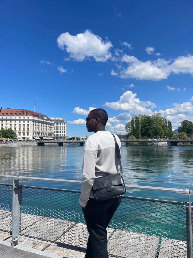 Idrissa Sow, software engineer, standing by the Seine in Paris